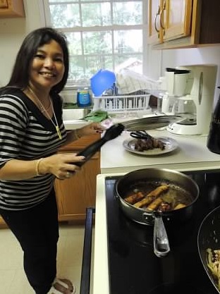 My mom cooking away while we decorated. =]